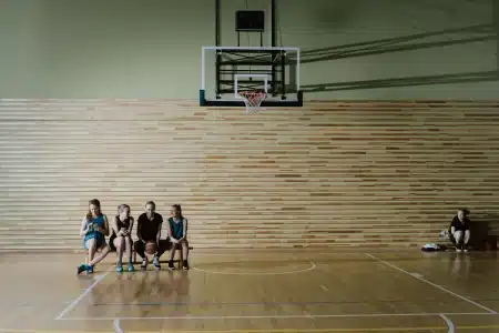 Deux joueuses de basket-ball en action lors d'un match, une tentant un tir rapide sous la pression d'une défenseure.