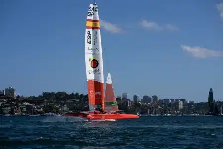 Catamaran de course SailGP filant à grande vitesse sur l'eau avec ses voiles gonflées