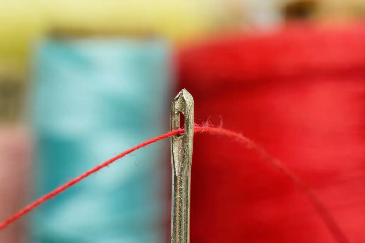 Détail de tissu et ciseaux de tailleur illustrant la coupe et la matière